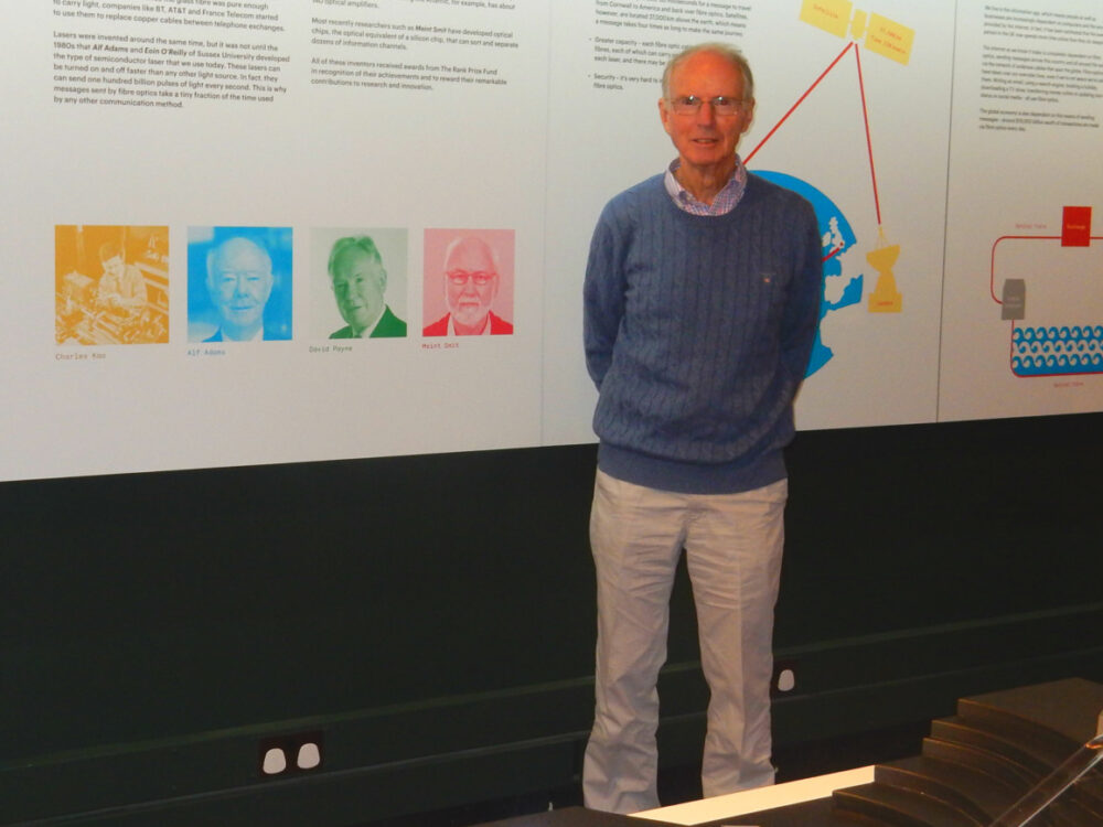 The photograph shows Peter in our new fibre optic gallery with images of his colleague Charles Kao and other inventors in the background.